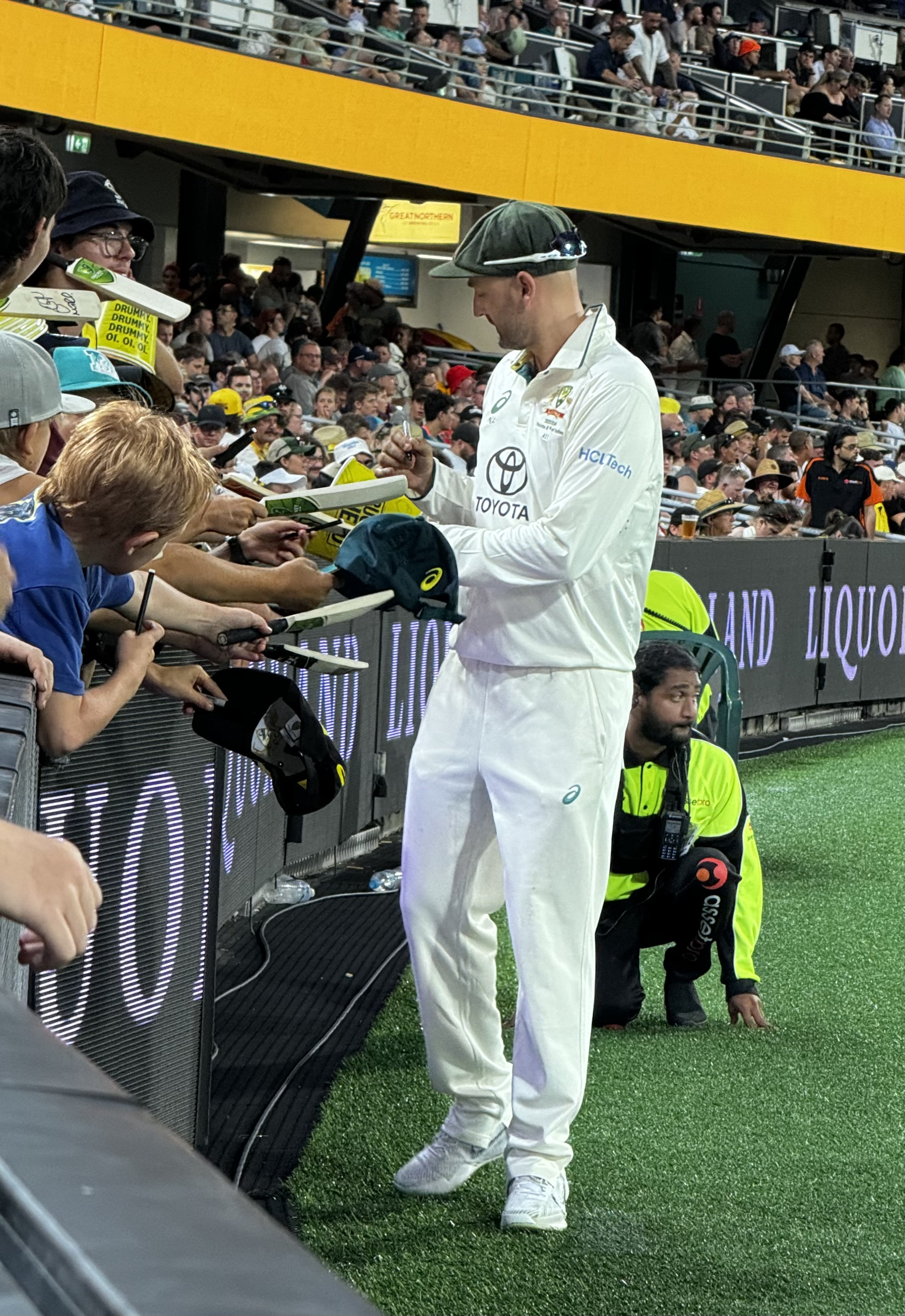 Nathan Lyon doing Autographs between deliveries